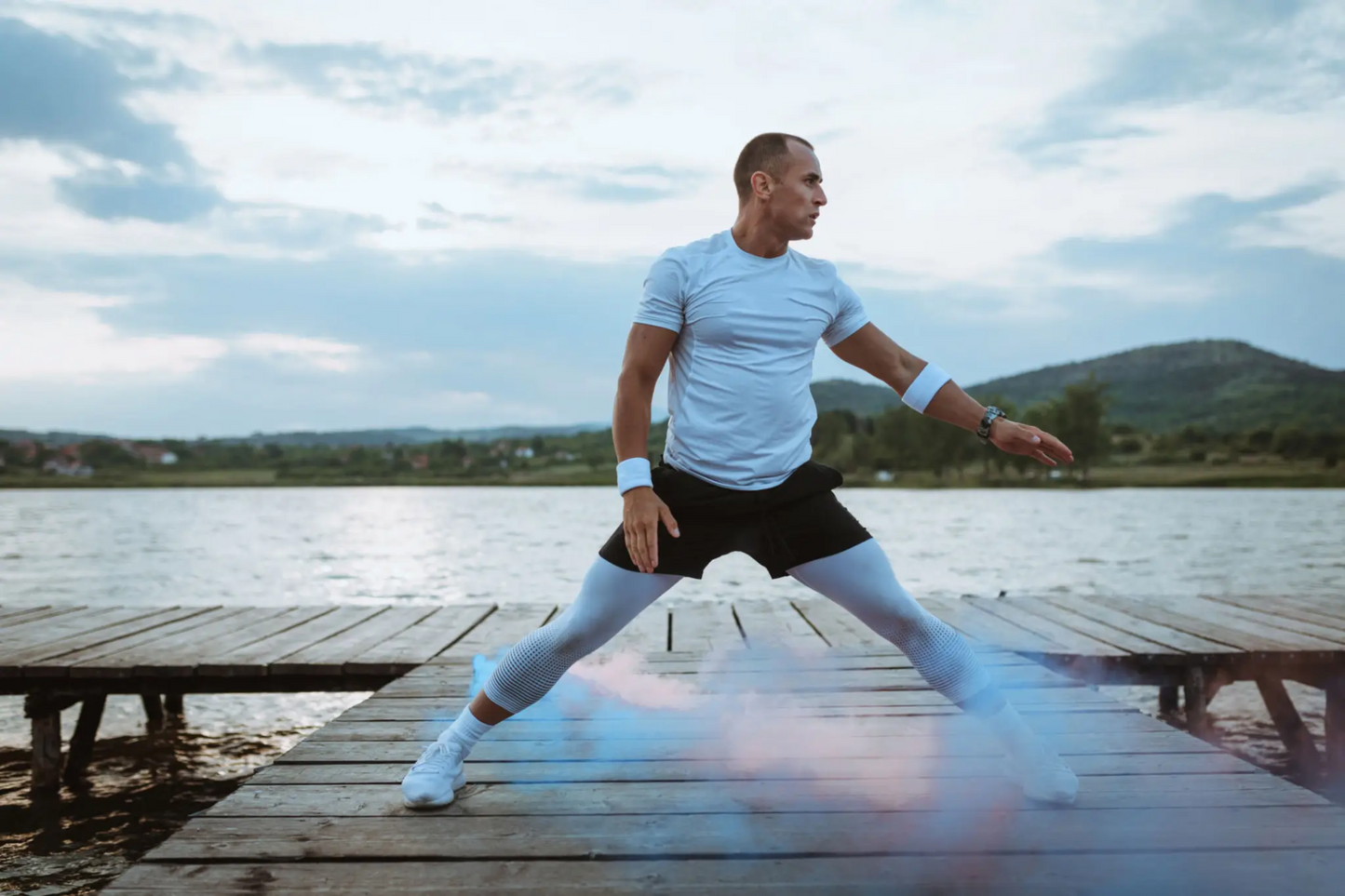 Man performing dynamic stretches outdoors, representing the benefits of Sermorelin peptide therapy for energy, muscle growth, and anti-aging